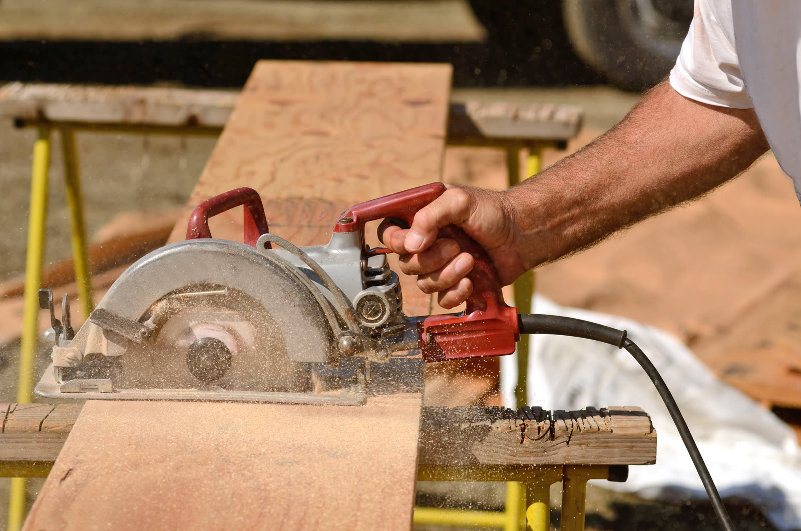Building contractor worker using hand held worm dr — the kind of handyman work vetted local pros handle in Sarasota, FL
