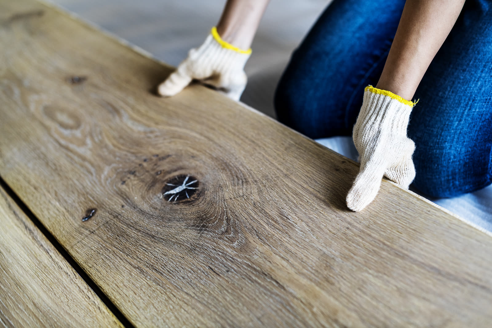 Carpenter man installing wooden floor — the kind of handyman work vetted local pros handle in Sarasota, FL