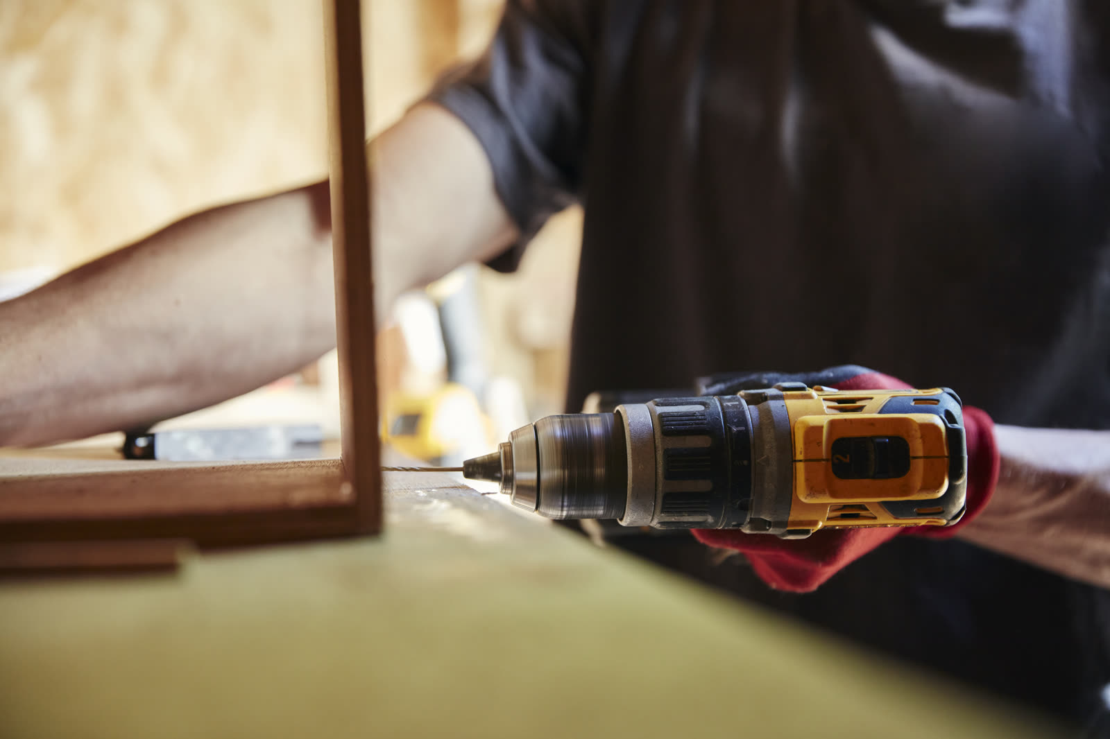 Carpenter using a drill — the kind of handyman work vetted local pros handle in Sarasota, FL