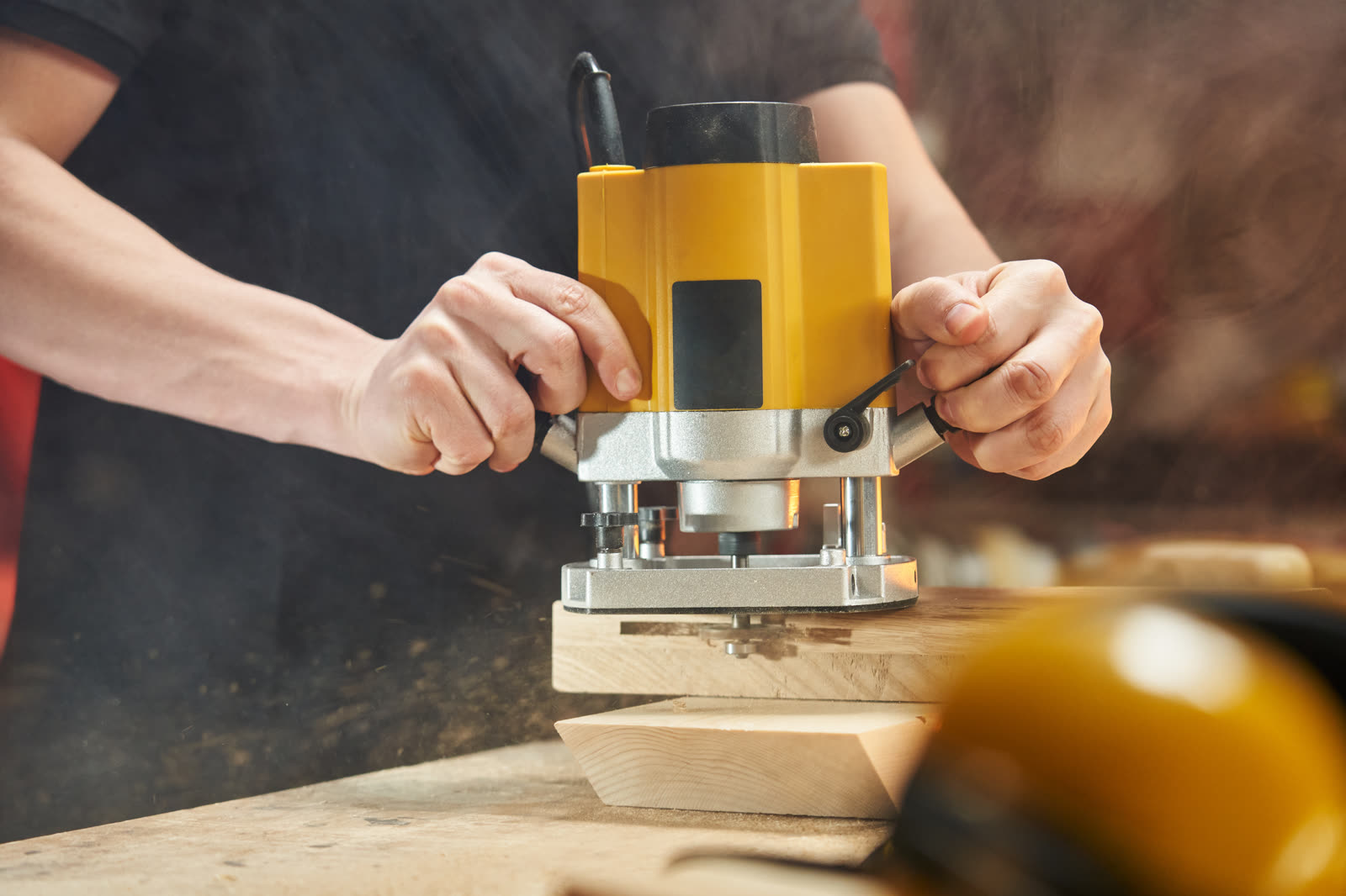 Caucasian worker makes a groove in a wooden blank — the kind of handyman work vetted local pros handle in Sarasota, FL