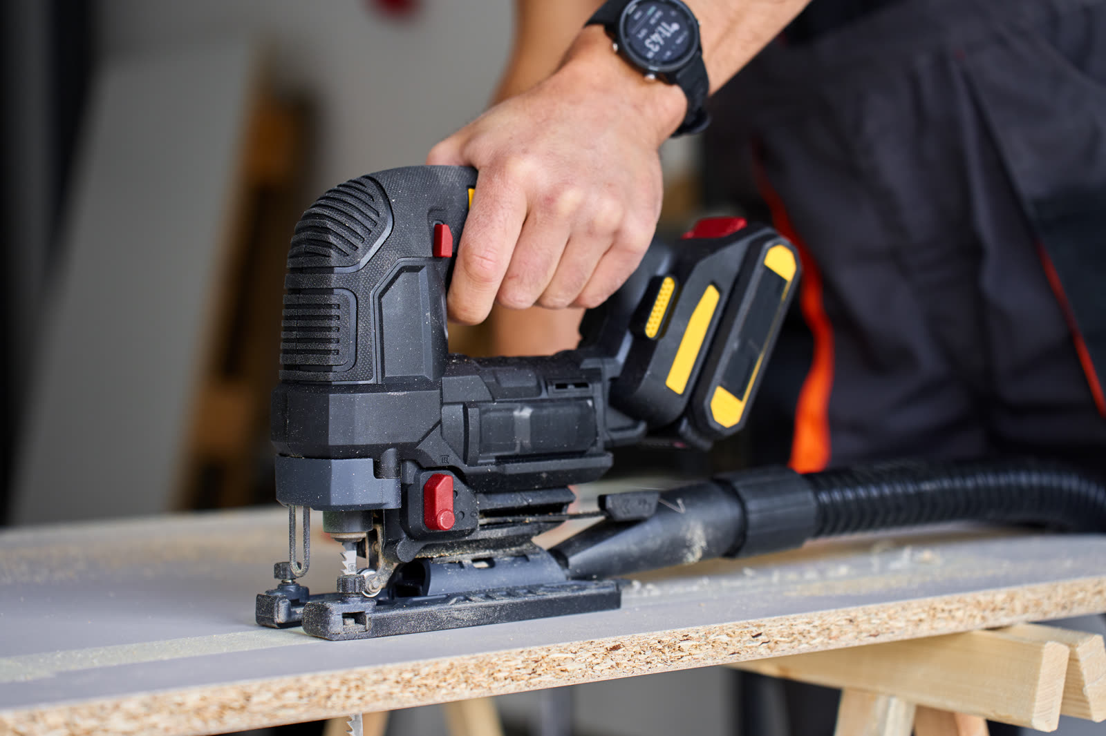 Close up of electric jigsaw cutting wood panel — the kind of handyman work vetted local pros handle in Sarasota, FL