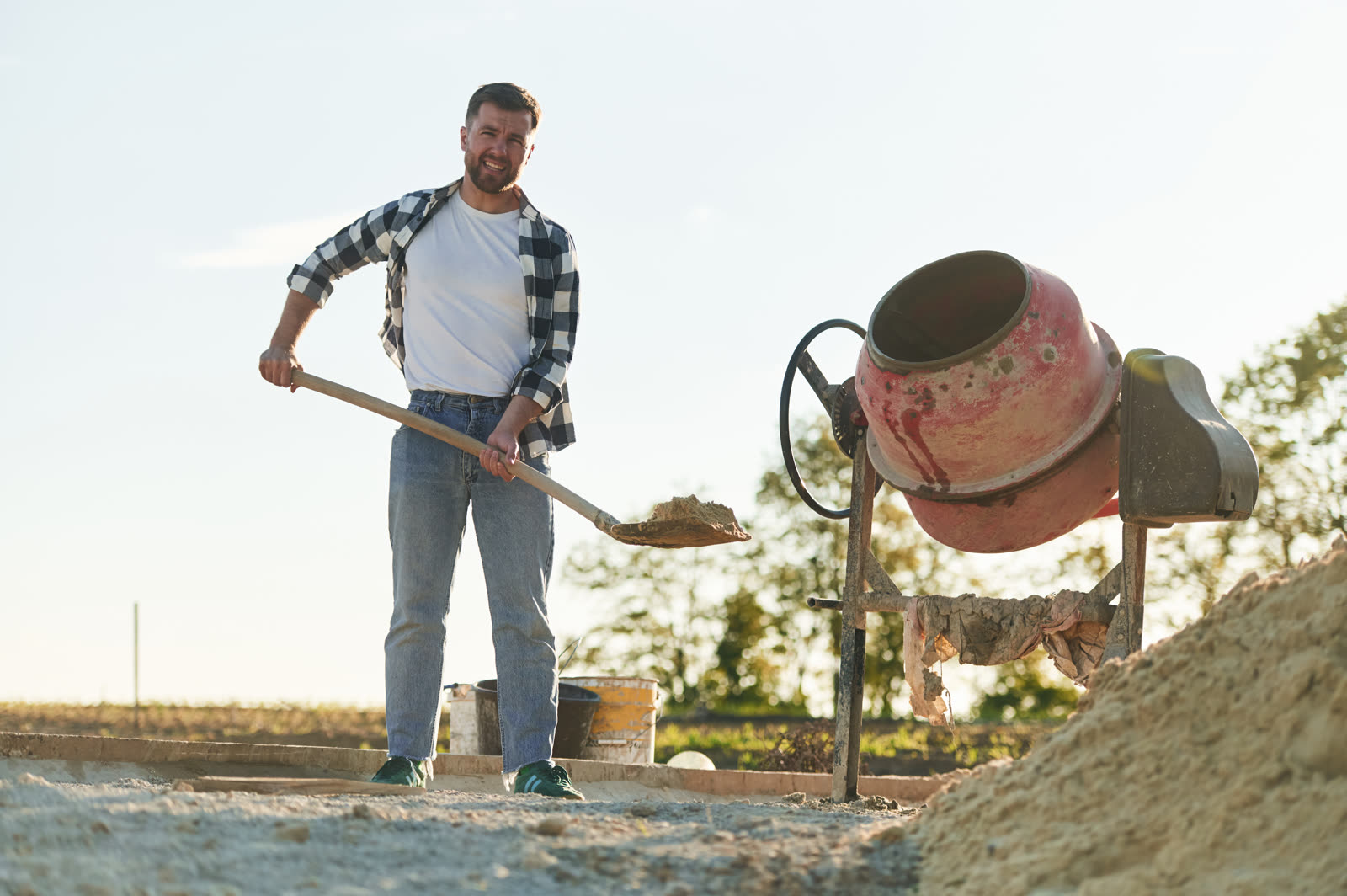 Construction worker is with shovel and concrete mi — the kind of handyman work vetted local pros handle in Sarasota, FL
