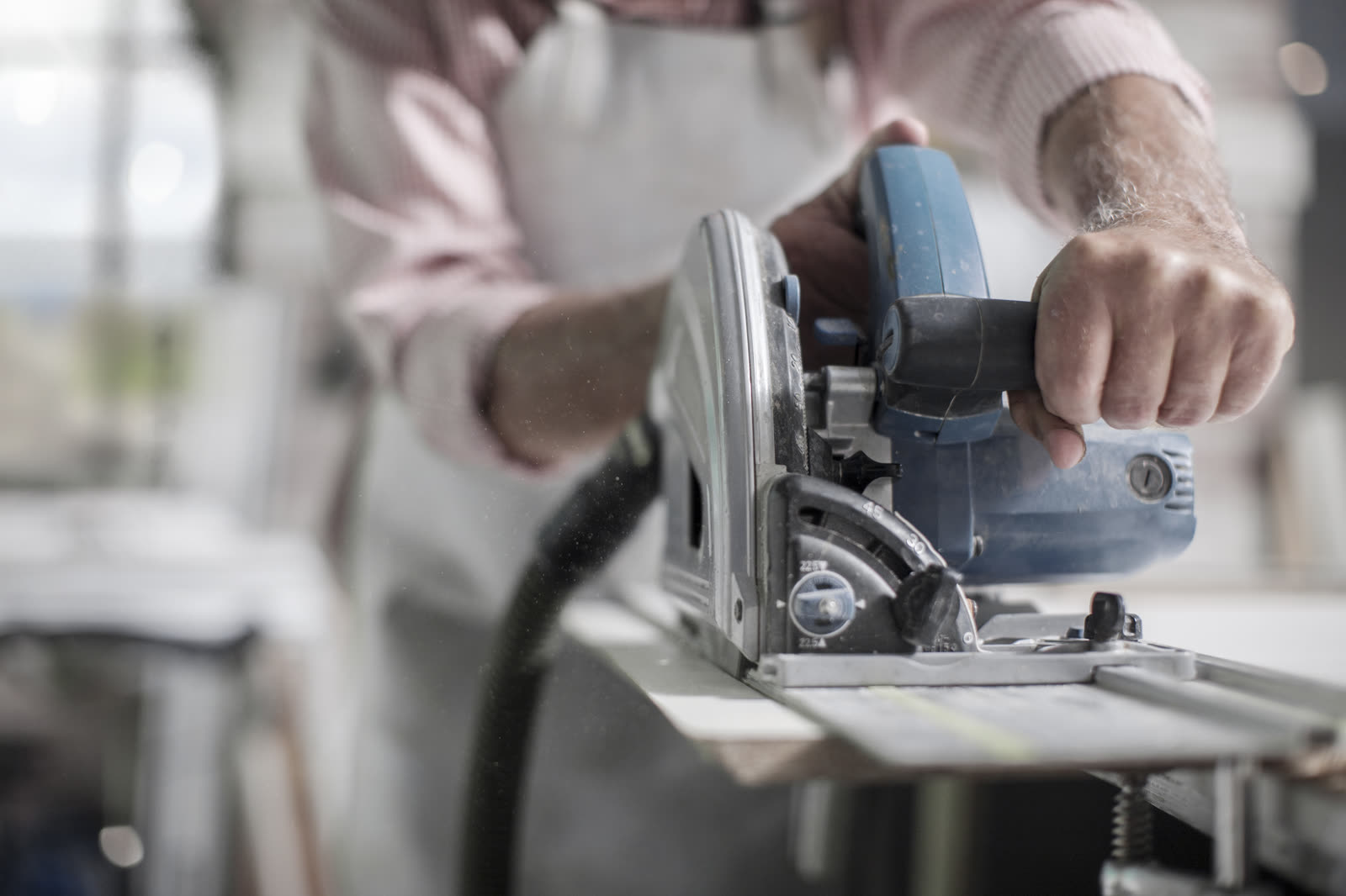 Cropped shot of senior carpenter using machine in — the kind of handyman work vetted local pros handle in Sarasota, FL