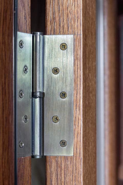 Door hinge metal door loop established on a woode — the kind of handyman work vetted local pros handle in Sarasota, FL