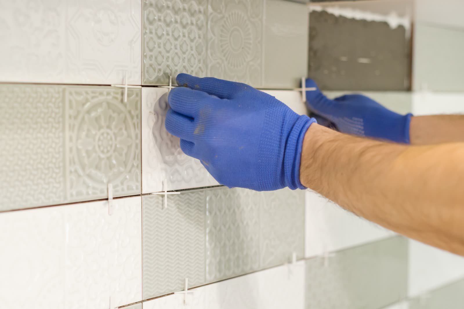 Installing ceramic tiles on the wall in kitchen — the kind of handyman work vetted local pros handle in Sarasota, FL