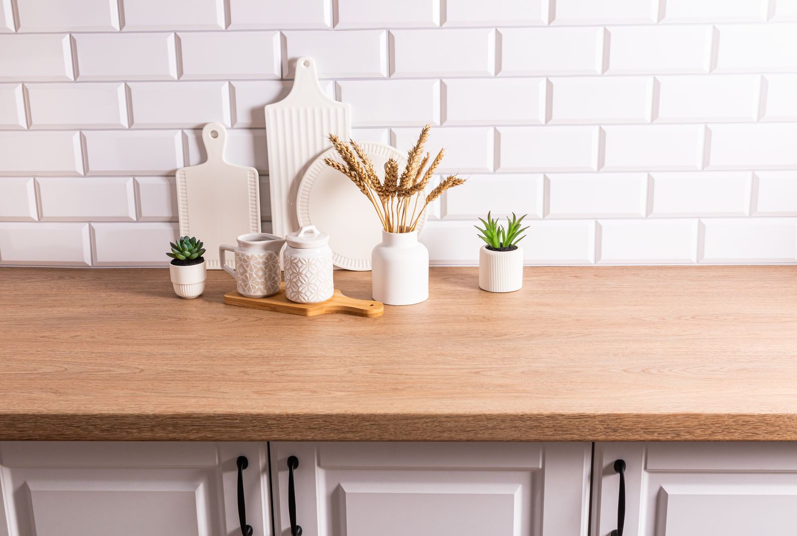 Kitchen countertop decor with plants and wheat — the kind of handyman work vetted local pros handle in Sarasota, FL