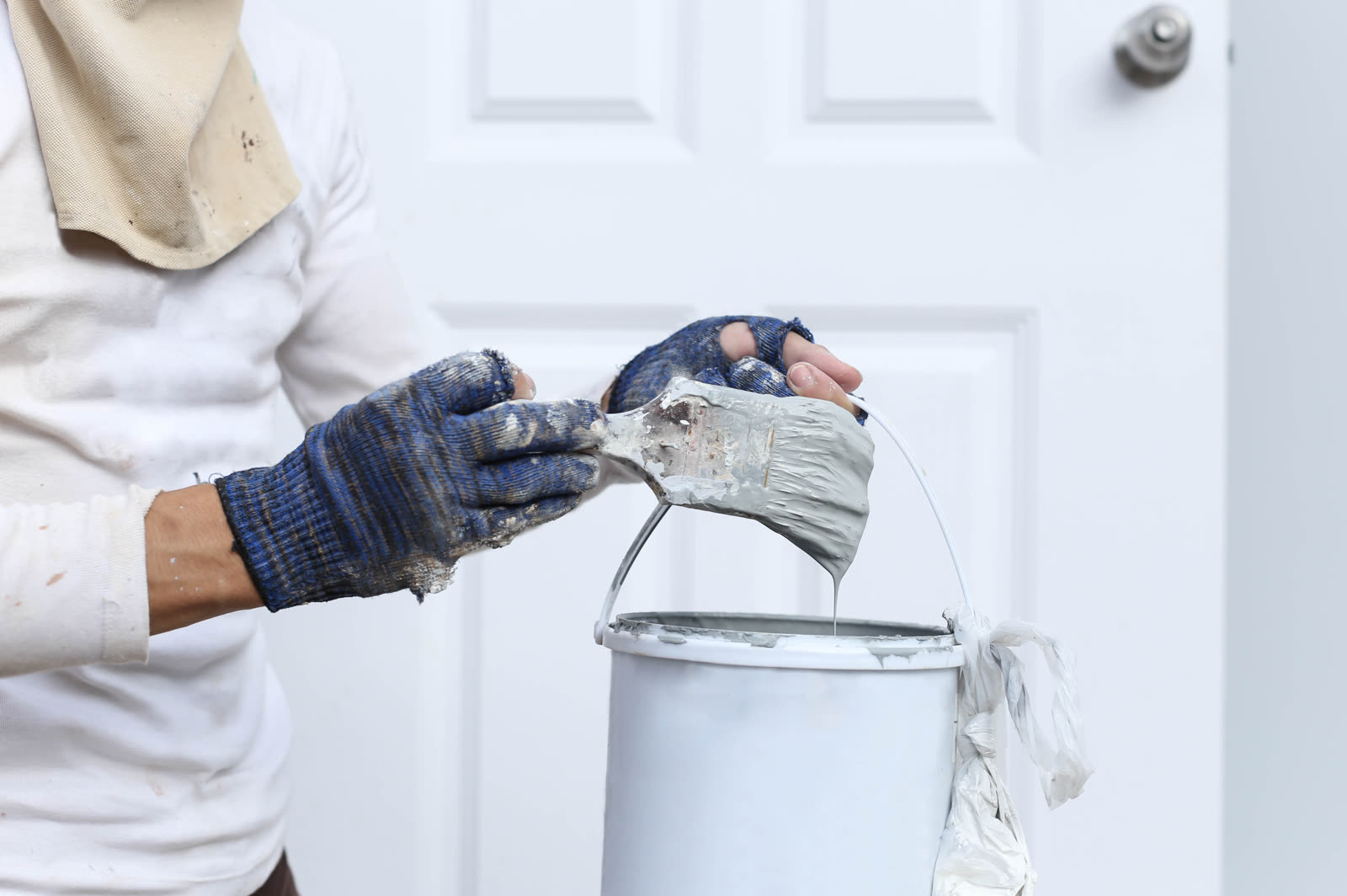 Painter hand holding paint brush for decorating — the kind of handyman work vetted local pros handle in Sarasota, FL