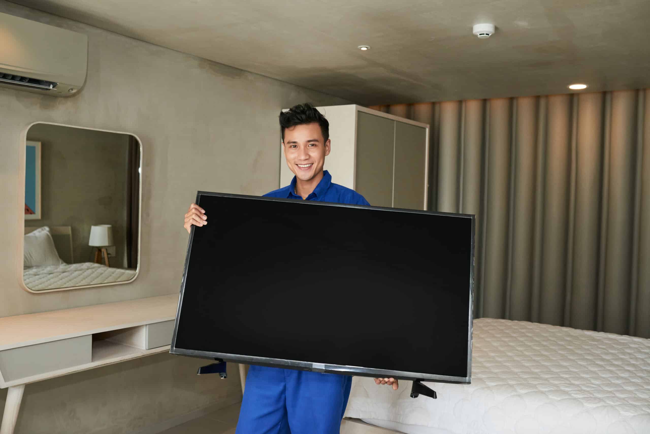 Technician with tv set — the kind of handyman work vetted local pros handle in Sarasota, FL