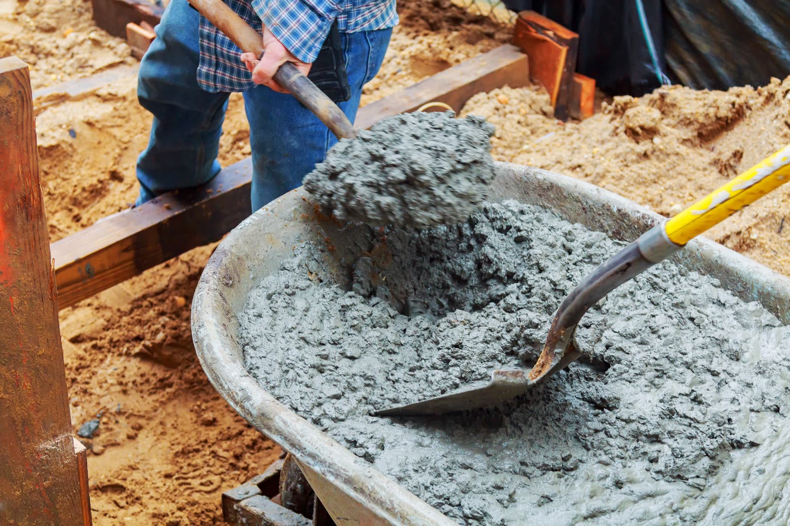 Worker pouring concrete to formwork at constructio — the kind of handyman work vetted local pros handle in Sarasota, FL