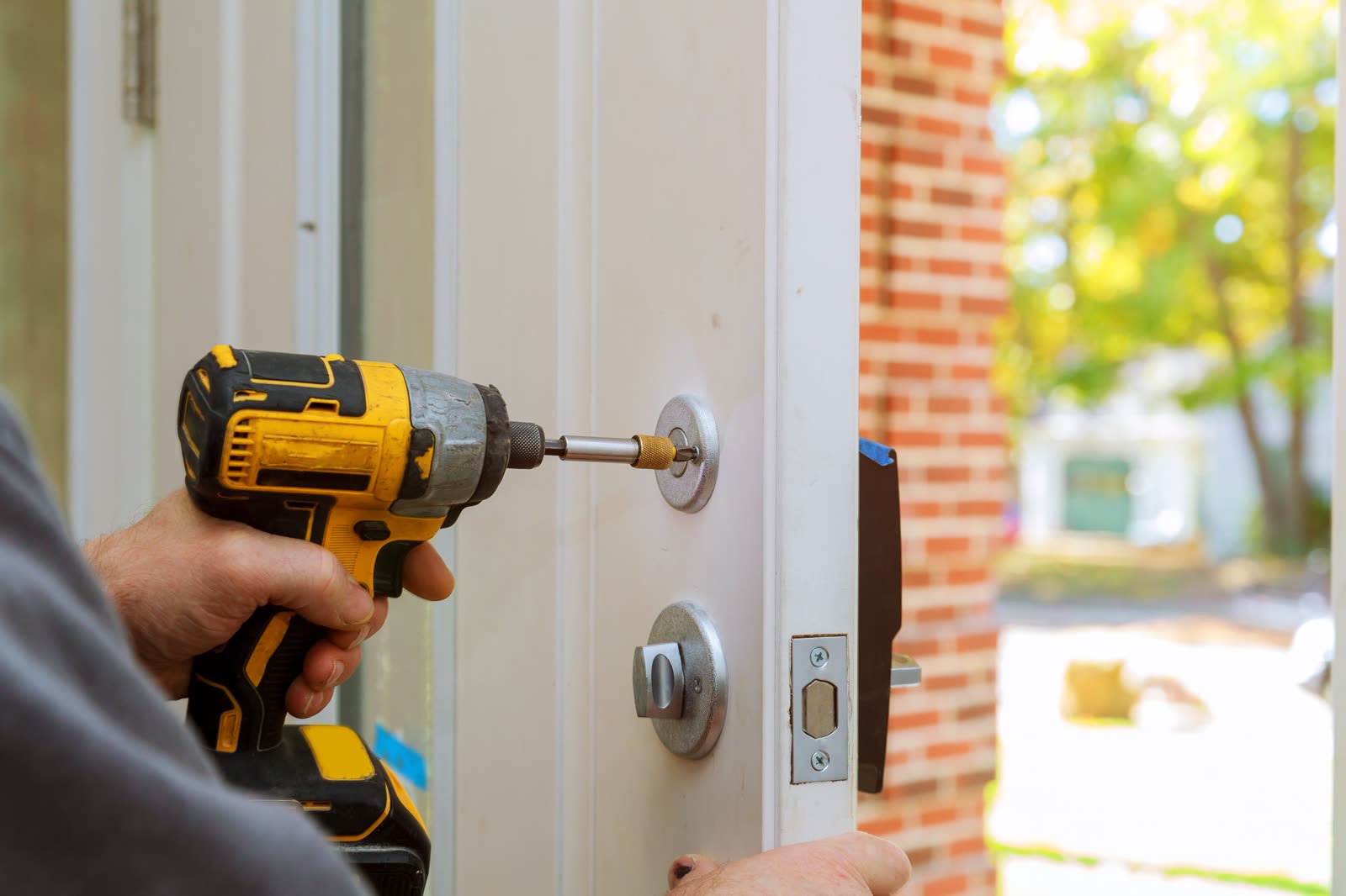 Deadbolt installed on an exterior door with a cordless drill