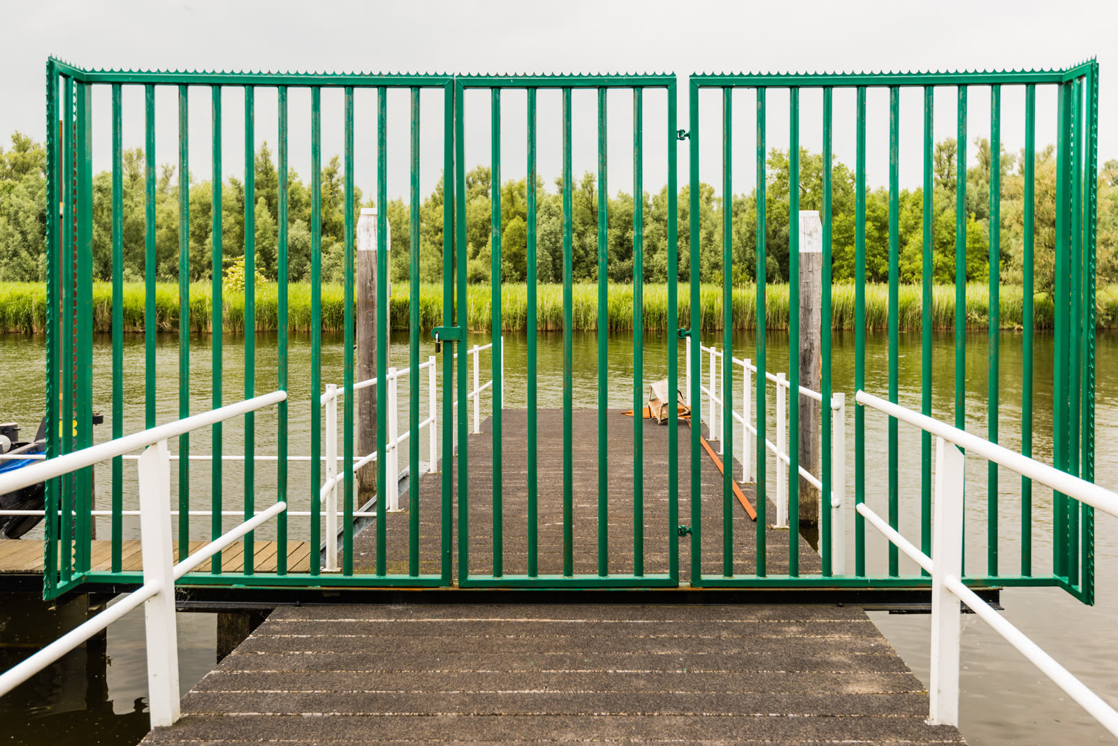 Green painted steel gate on a jetty sealed with a — the kind of handyman work vetted local pros handle in Sarasota, FL