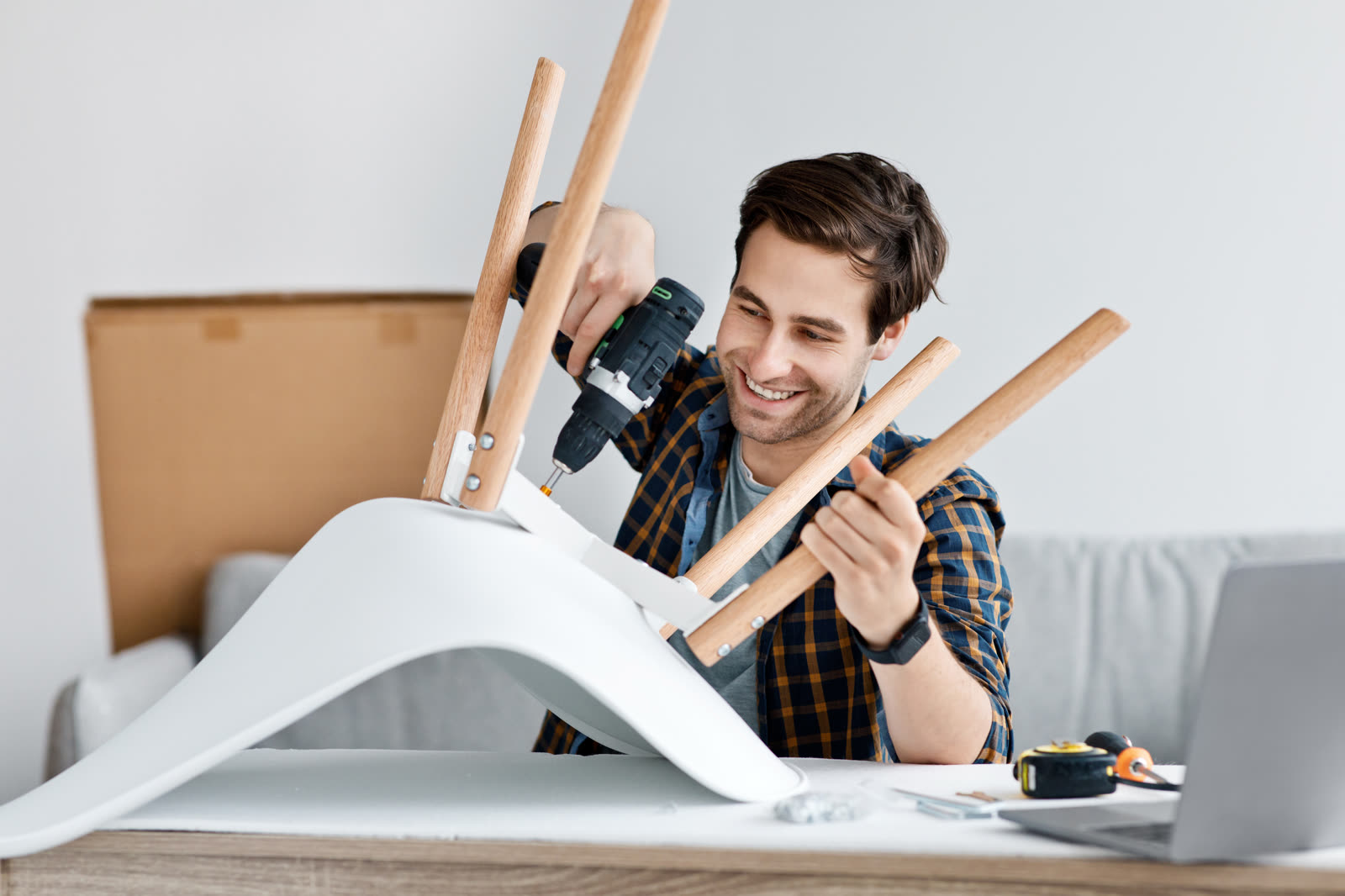 Man fixing furniture repairing wooden chair usin — the kind of handyman work vetted local pros handle in Sarasota, FL