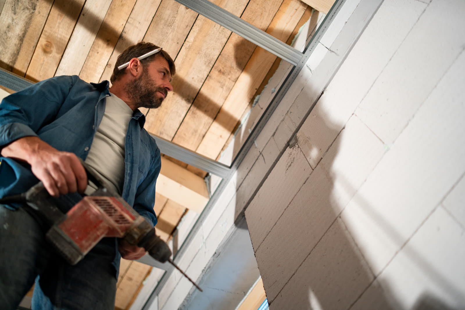 Low angle view of handyman working with drill on c — the kind of handyman work vetted local pros handle in Sarasota, FL