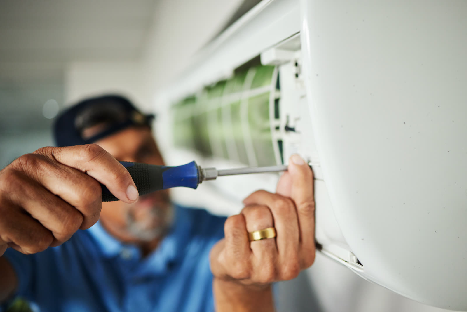 Electrician hands and air conditioning with man a — the kind of window ac installation our vetted local pros handle in Sarasota, FL
